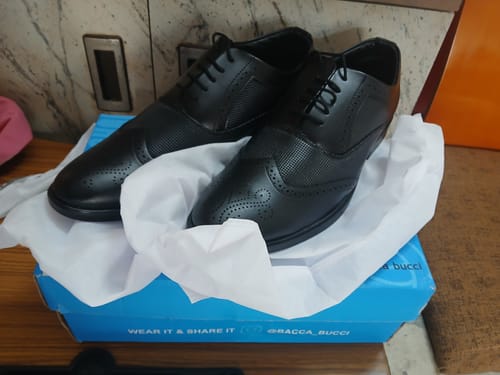 Customer's black Bacca Bucci VICTORIA Formal Shoes resting on tissue paper in the open shoebox.