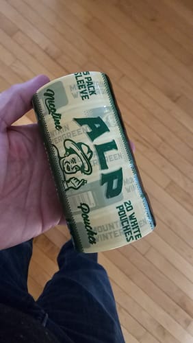 Customer holding a 5-pack sleeve of Mountain Wintergreen Nicotine Pouches.