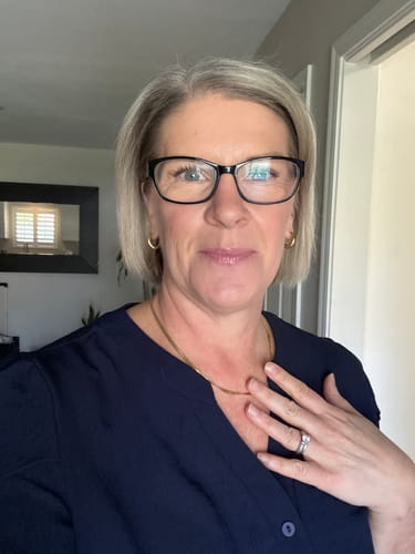 A reviewer wears the classic Chelsea Herringbone Necklace, which lays flat against her collarbone.