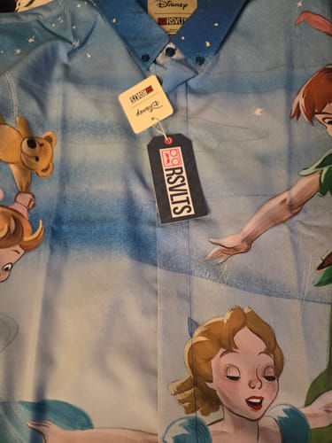Close-up of a customer's Disney Peter Pan shirt, showing the detailed character art and attached tags.