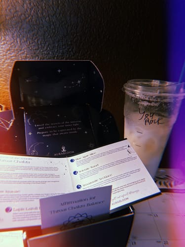 Customer unboxing their VIP Crystal Club monthly tester, showing the decorative box and included affirmation cards.