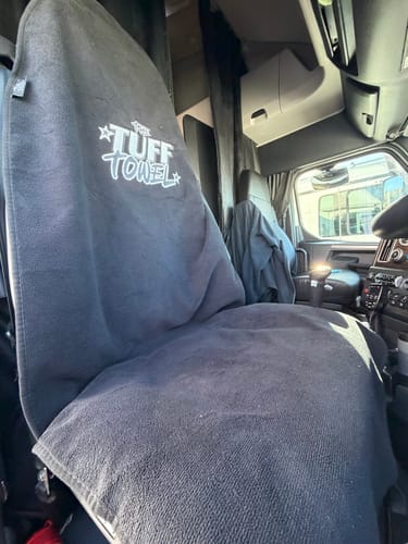Customer's dark grey Waterproof Car Towel Seat Cover fitted over the driver's seat in a truck.