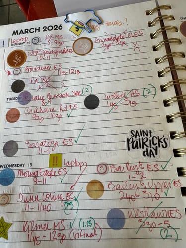 Customer uses colorful Monet Garden Watercolor Dot Stickers to organize appointments in a weekly planner.