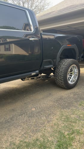 Customer's black truck with a KSP Traction Bar and shiny stainless steel plate installed underneath.