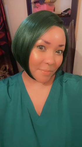 Customer wearing the sleek Chic Bob wig in a vibrant Sapphire Green color.