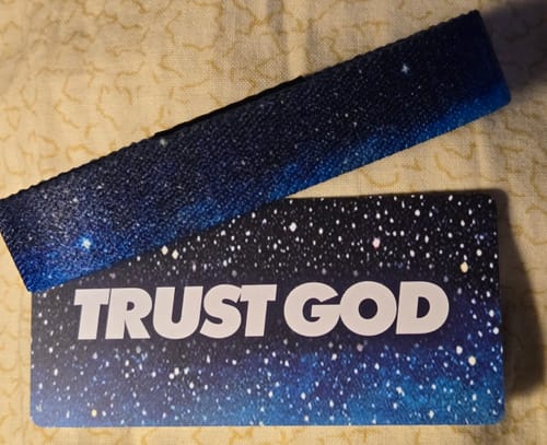 Customer's Trust God Bible Verse Bracelet with a galaxy print, shown with its matching 'TRUST GOD' packaging card.