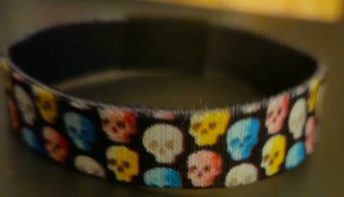 Close-up of a customer's Choose Today Bracelet, showing the colorful skull pattern on the black outer band.