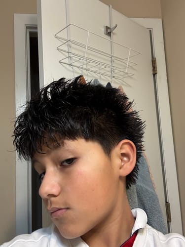 Reviewer from the side showing their textured black hair after using the Sea Salt Spray.