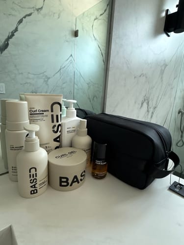 Customer's Body Lotion from BASED, shown with other products from the collection on a bathroom counter.