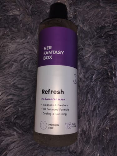 Customer's bottle of Her Fantasy Box Refresh pH-Balanced Wash on a soft gray surface.