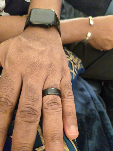 Close-up of a customer wearing the matte black Umbra ring on their ring finger.