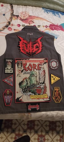 Customer's Gore Metal comic backpatch from the Exhumed set sewn as the large centerpiece on a gray vest.