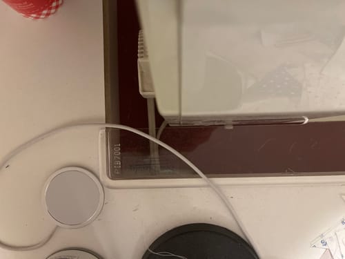 Close-up of the customer's clear Sew Steady Cabinet Insert fitted around the base of a sewing machine.