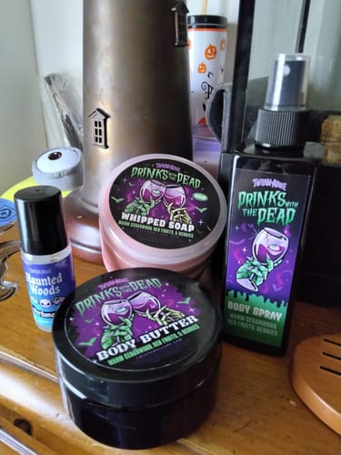 Customer's Drinks with the Dead Body Spray displayed with matching body butter and whipped soap on a wooden surface.
