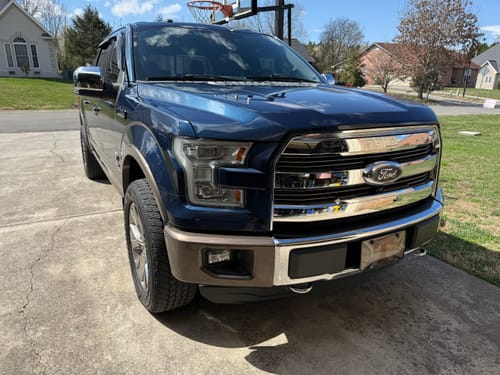 Customer's dark blue Ford F150 parked, showing a wider stance after installing 1.5-inch hubcentric wheel spacers.