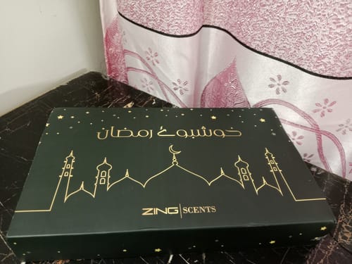 Customer's packaging for the Khushboo-e-Ramzan oud bundle, a dark green box with gold graphics.