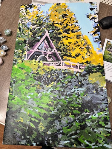 Reviewer's colorful paint-by-numbers canvas showing a detailed forest scene with a cabin.
