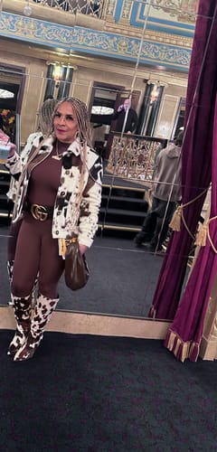 Reviewer posing in a mirrored room, showing off the full-length brown Naked Closed Toe Jumpsuit.