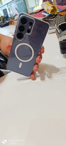 Reviewer shows the back of their phone, which is protected by the UltraShield Tempered Glass on the front.