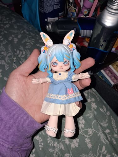 Customer holding a Bonnie Season 2 action figure. The doll has blue hair, bunny ears, and a detailed blue and white dress.