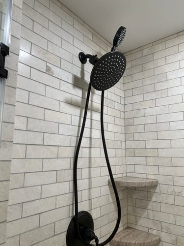 Customer's black metal 1-Spray Dual Shower Head Set installed in a tiled shower.