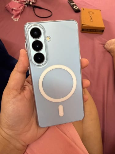 Customer holding a light blue Samsung phone with the clear Magsafe case installed, showing the back.