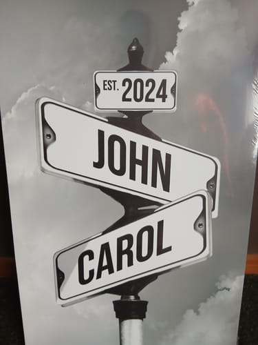 Customer's personalized 'Date of Love' canvas with vintage street signs reading 'John', 'Carol', and 'Est. 2024'.