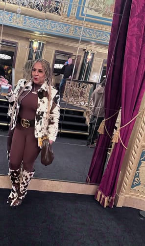 Customer's full-body view of the brown Naked Closed Toe Jumpsuit, styled with a jacket and boots.
