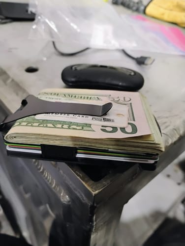 Customer's Tactical Wallet holding a thick stack of cash and multiple cards.
