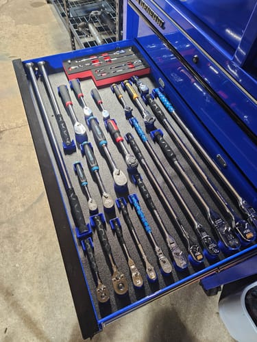 Customer's blue DrawerPro Handle Holders neatly organizing various ratchets and bars in an open tool drawer.