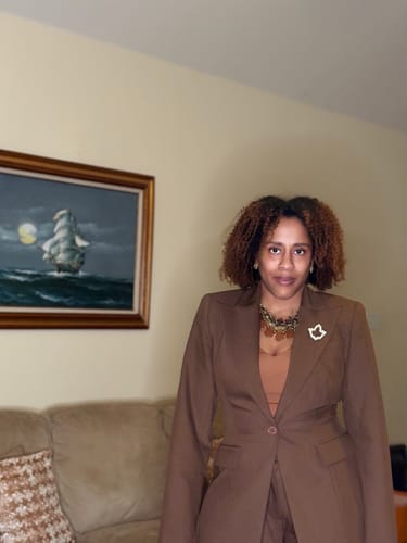 Partial view of the reviewer wearing the suiting set, including the Pleated Wide-Leg Pant.