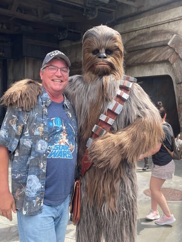 Reviewer wearing the Star Wars A New Hope Poster Art T-Shirt while posing with Chewbacca.