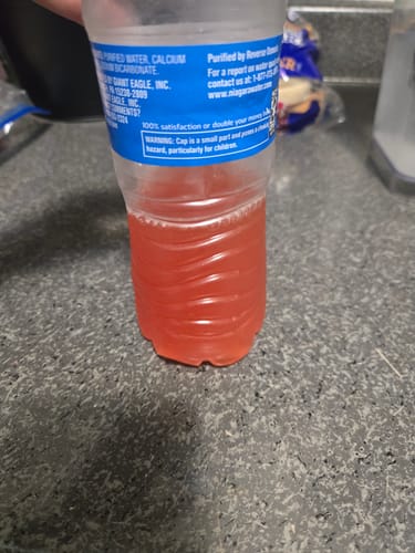 Customer's reddish Migranium Daily drink mixed in a half-full water bottle.