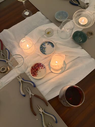 Reviewer photo of the intimate table setting for the Fine & Wine master class, with tools, candles, and wine.