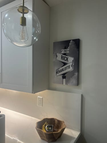 Reviewer's personalized COUPLES DATE OF LOVE canvas with a street sign design hanging on a modern kitchen wall.