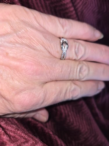 Customer wearing the sparkling Forever Linked Knot Ring on their finger.