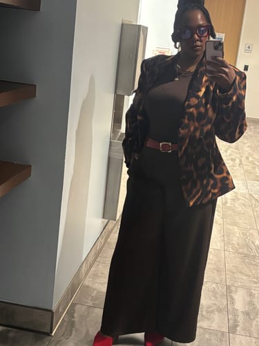 Reviewer wearing the Suiting Tortoise Sculpted Blazer styled over a brown top and matching wide-leg pants.
