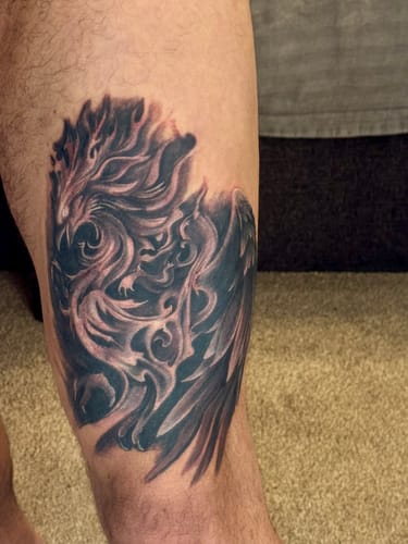 Customer shows a detailed black and grey tattoo on their leg, with minimal redness after a long session.