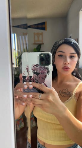 Reviewer shows off their stylish SUKUNA - JUJUTSU KAISEN phone case in a mirror selfie.