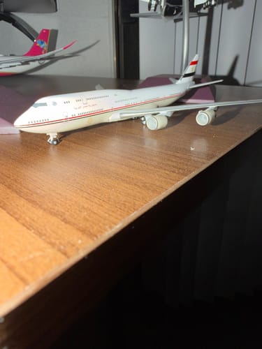 Close-up of the customer's HERPA EGYPT GOVERNMENT 747-8 model airplane sitting on a wooden desk.