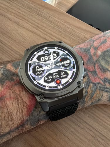Customer's Gard Pro Ultra 3 on a tattooed wrist, showing a digital face with health stats and a black fabric strap.