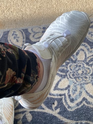 Customer's close-up of the white Lorax Pro barefoot shoe, showing the patterned upper and elastic laces while being worn.