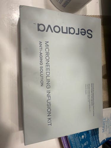 Customer's Seranova Microneedling Infusion Kit in its light green box on a table.
