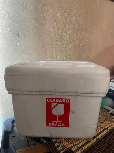 Cliente muestra la caja de envío de unicel para Prolia 60 mg, con una calcomanía de 'Frágil'.
