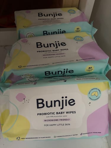 Customer's large stack of Bunjie Probiotic Baby Wipes packages on a shelf.