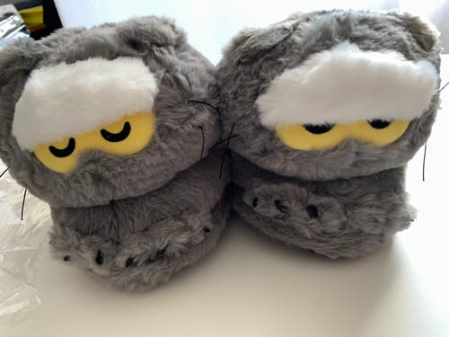 Customer's fluffy grey Zoa Home Shoes, featuring the cute character face with yellow eyes.