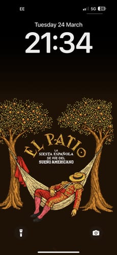 Reviewer's phone lock screen showing the La Siesta Wallpaper with an illustrated matador sleeping in a hammock.