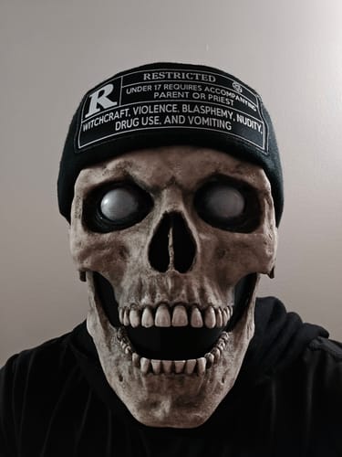 Close-up of a customer wearing the black Rated R Beanie over a skull mask.