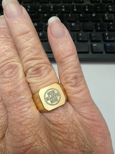 Customer wearing the gold Matte & Shiny Signet Ring with an engraving on their hand.