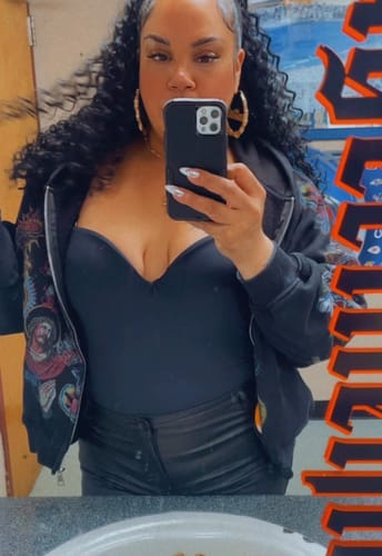 Customer wearing the graphic Righteous Risen King Zip Up Hoodie Black unzipped in a mirror selfie.